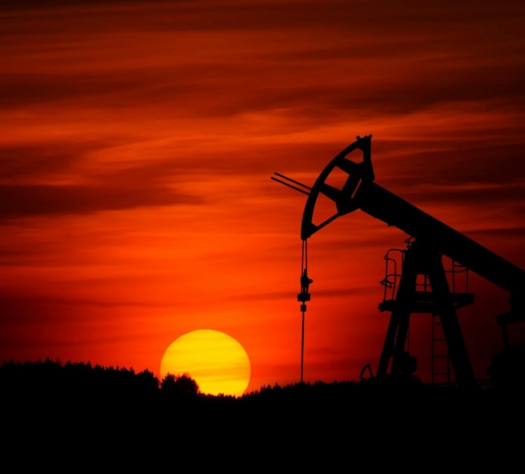 oil pump jack in sunset