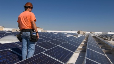 Engineer checking the solar panels installed on ground