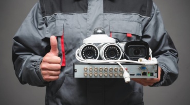 Technician holding different types of cameras